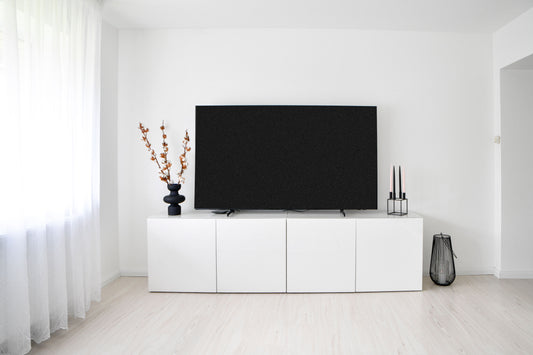 Minimalist white TV console in a bright Scandinavian-style living room